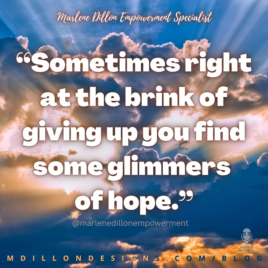 Marlene Dillon Empowerment Specialist’s quote: “Sometimes right at the brink of giving up you find some glimmers of hope.” appears in large, bold white lettering with a dark shadow over a dramatic blue sky filled with clouds and golden sunlight streaming through them. Her name appears in white script at the top, with @marlenedillonempowerment beneath the quote, the Share & Let’s Live! podcast logo in the lower-right corner, and MDILLONDESIGNS.COM/BLOG along the bottom